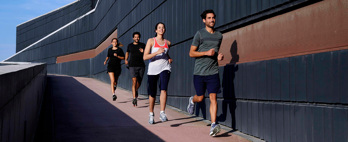 Men and women modelling clothing from the Asics outlet