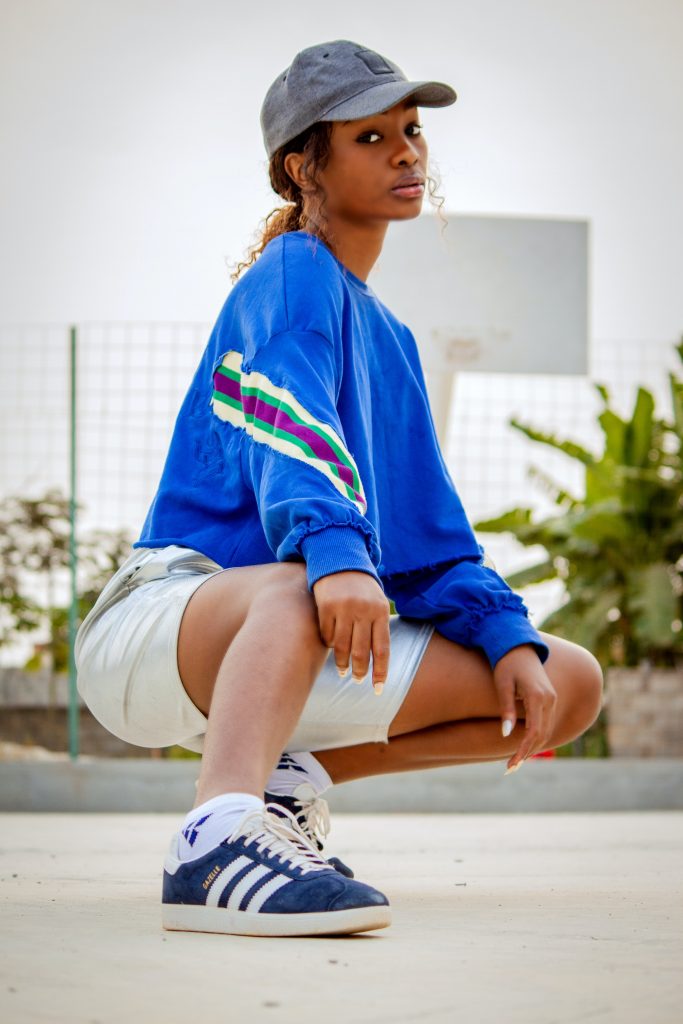 Girl in sweatshirt, shorts and trainers