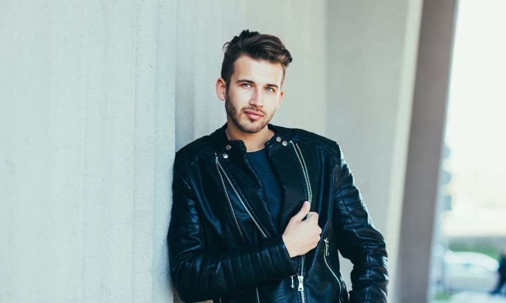 Man wearing black leather jacket inspired by 80s fashion.